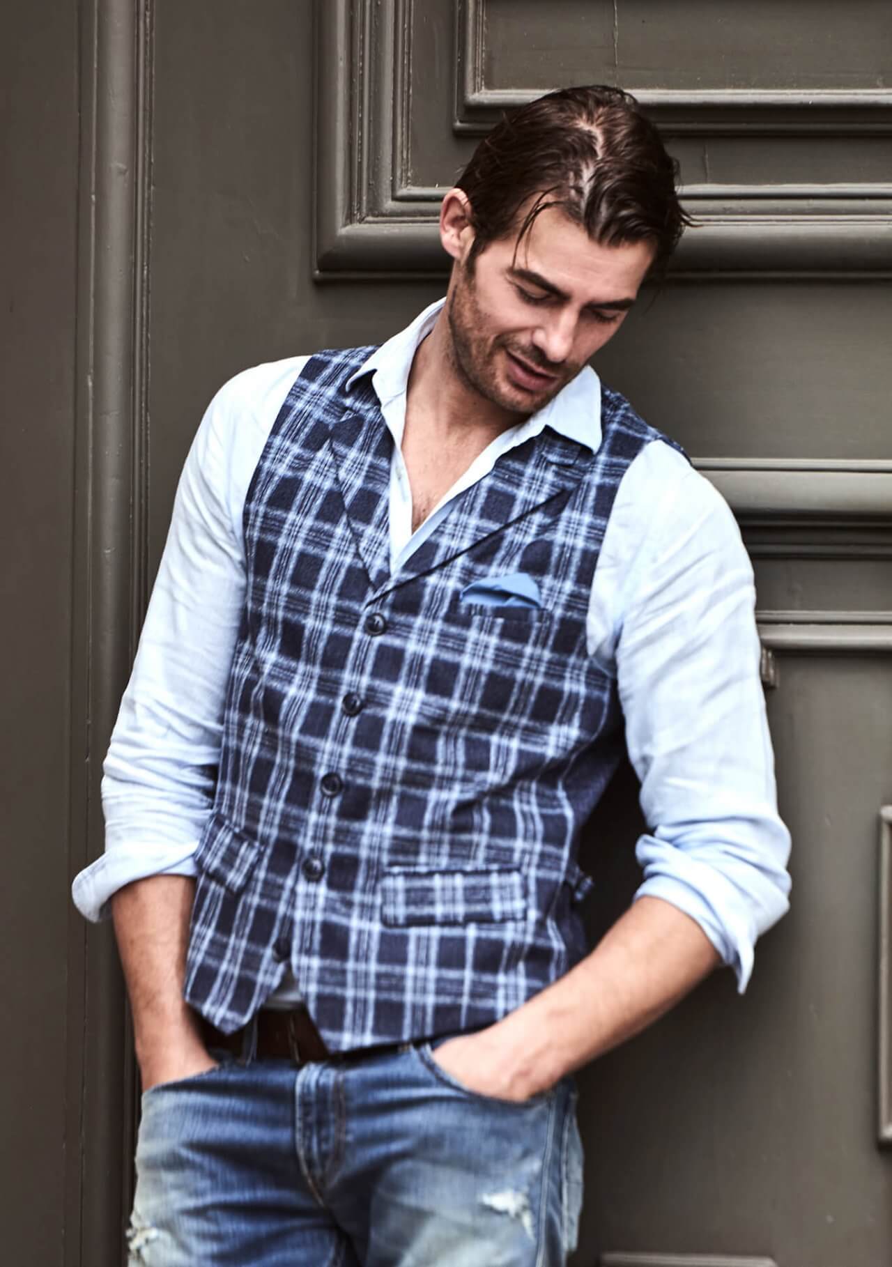 Model trägt DORNSCHILD Herrenweste mit Revers in Nachtblau mit hellblau-silbergrauem Karomuster im smart-casual Sommer-Look